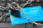 credit card ban card on keyboard with chain and padlock
