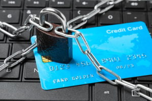 credit card ban card on keyboard with chain and padlock