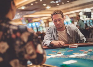 man playing blackjack studying cards