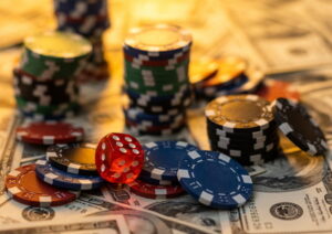 casino chips and dice on carpet of cash