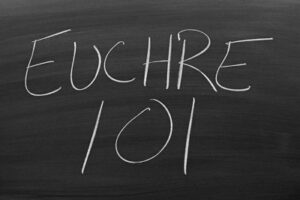 euchre 101 written in chalk on blackboard